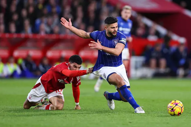 Morgan Gibbs-White of Nottingham Forest tackles Sam Morsy