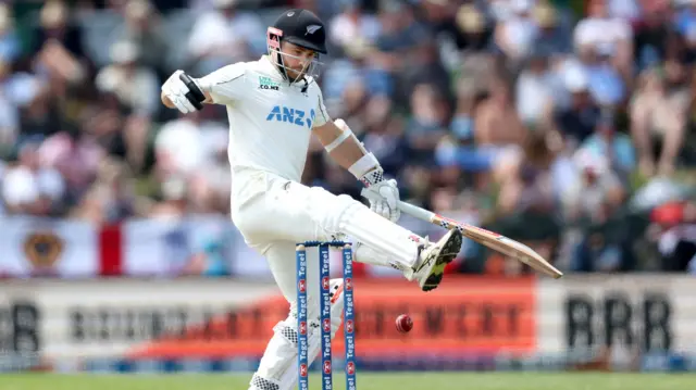 Kane Williamson kicks the ball