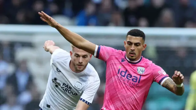 West Brom's Karlan Grant holds off a Preston player