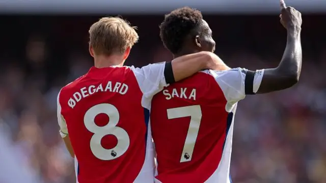 Bukayo Saka of Arsenal celebrates scoring his team's first goal with teammate Martin Odegaard