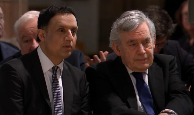 Gordon Brown sitting next to Scottish Labour leader Anas Sarwar