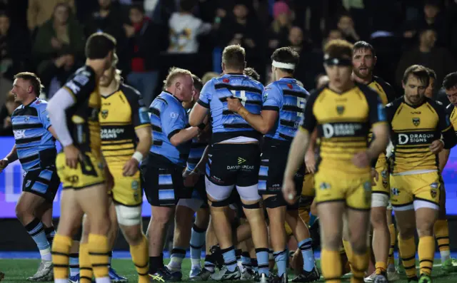 Cardiff players celebrate scoring against Dragons