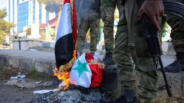 A Syrian national flag on fire