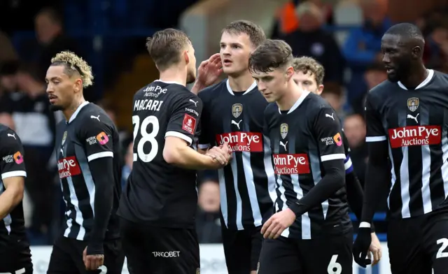 Notts County players celebrate with Matthew Platt