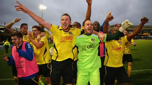 Chesham United players celebrate victory over Bristol Rovers in 2015