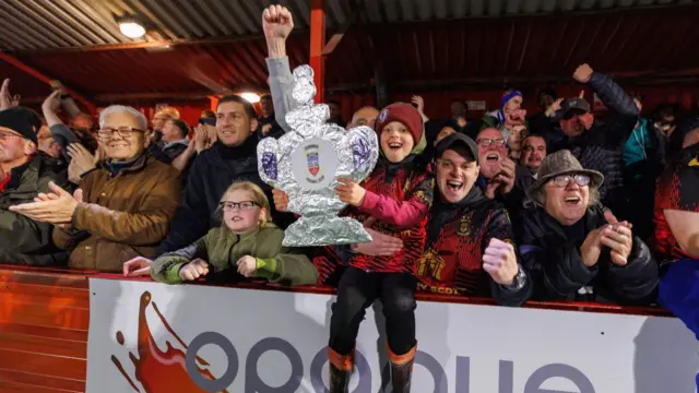 Tamworth fans celebrate their FA Cup victory over Huddersfield Town