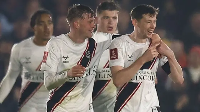 Conor McGrandles smiles after his goal at Chesham United