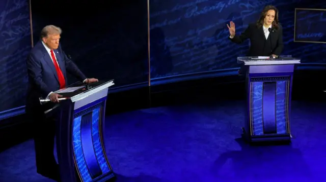 Trump and Harris behind podiums during a televised debate on ABC