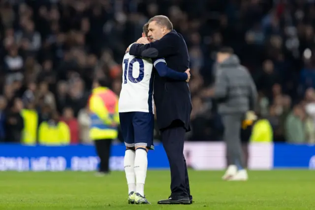 James Maddison of Tottenham Hotspur hugs Tottenham Hotspur manager Ange Postecoglou