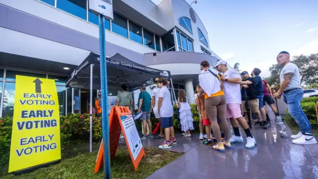 Voters queue in front of a polling station