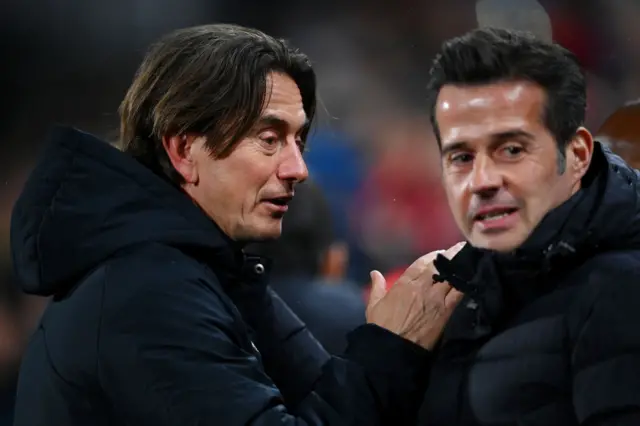 Thomas Frank, Manager of Brentford, speaks with Marco Silva, Manager of Fulham