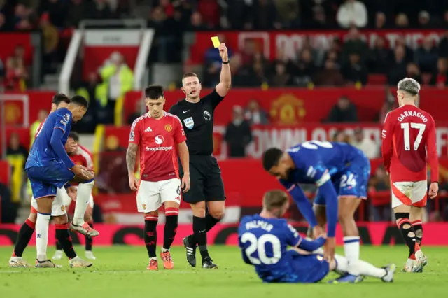 Lisandro Martinez is shown the yellow card