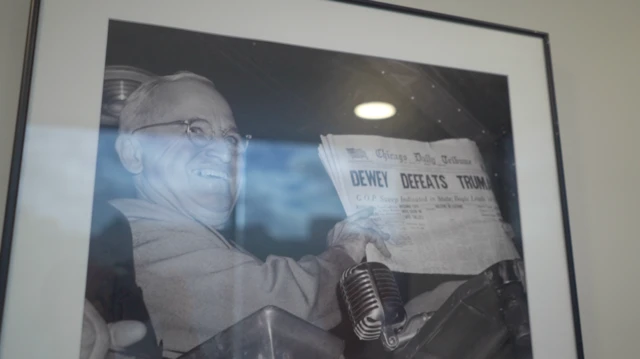 A framed photo of Harry Truman smiling with a newspaper headlined ‘Dewey defeats Truman’