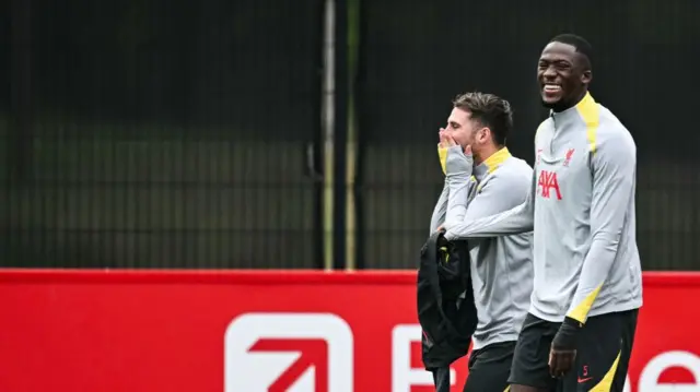 Liverpool's Argentinian midfielder #10 Alexis Mac Allister (L) and Liverpool's French defender #05 Ibrahima Konate laugh together