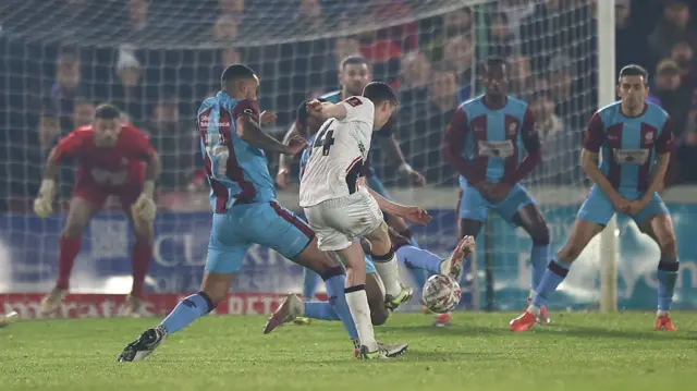 Conor McGrandles scores Lincoln's third goal at Chesham United