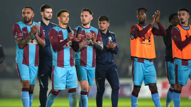 Chesham United players applaud their fans at full-time