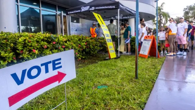 People wait in line to vote on Florida's last early voting day for the 2024 presidential election in Florida, at the Miami-Dade County Elections Department in Miami