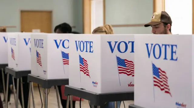 Voters cast ballots at a polling location at the Thomasville Library during the last day of early voting in Thomasville, North Carolina, US, on Saturday, Nov. 2, 2024.