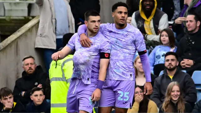 Zan Vipotnik places a ball under his shirt after scoring against Oxford