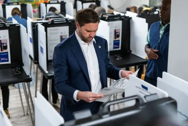 Republican nominee for vice president JD Vance looks over his ballot at a polling place