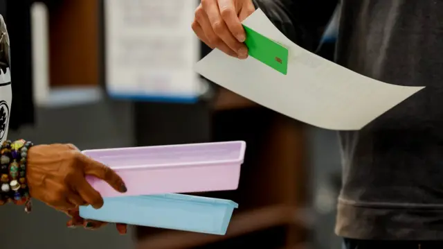 A voter prepares to scan their ballot in Atlanta, Fulton County