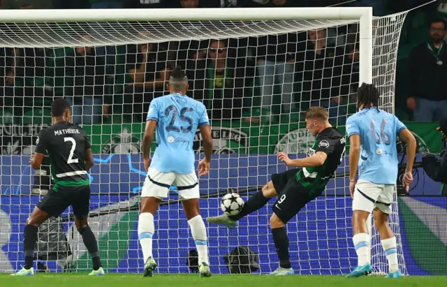Sporting defender hooks the ball off the line from a Haaland header