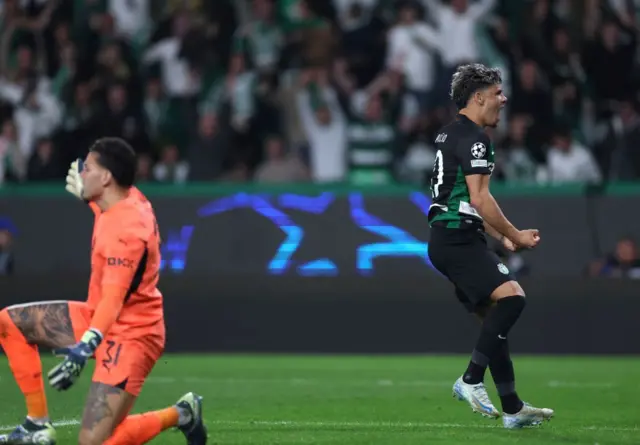 Araujo celebrates as Ederson kneels on the floor