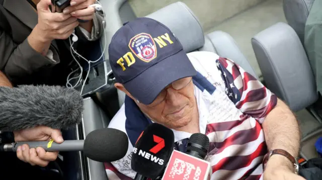 Rudy Giuliani is asked questions in the car