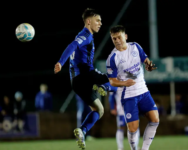 Igor Rutiski challenges for the ball