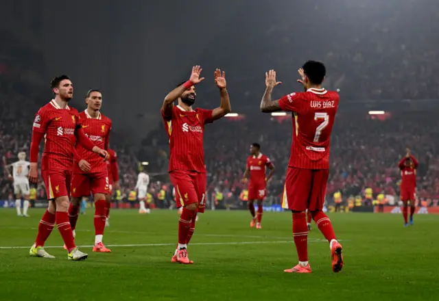 Liverpool players run to celebrate with Diaz