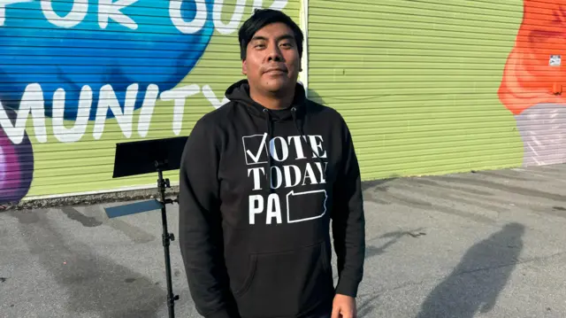 A man with a hoodie telling people to vote in Pennsylvania