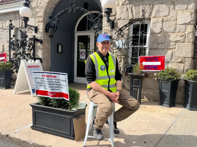 David Snow sat in a chair in front of a polling station