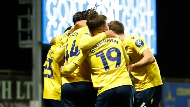 Oxford United players celebrate at the Kassam Stadium