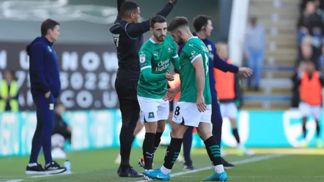 Plymouth captain Joe Edwards leaves the field injured