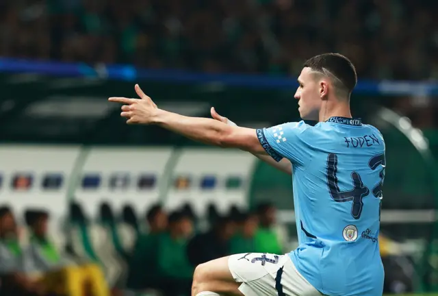 Foden does his sniper celebration after scoring