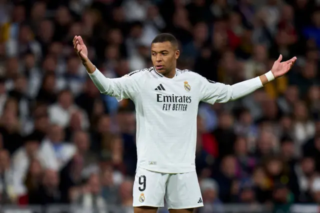 Real Madrid striker Kylian Mbappe holding his arms out