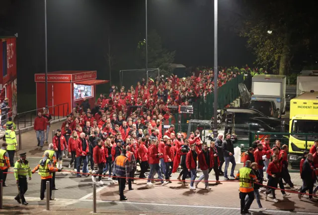 Leverkusen fans arrive at Anfield under police escort