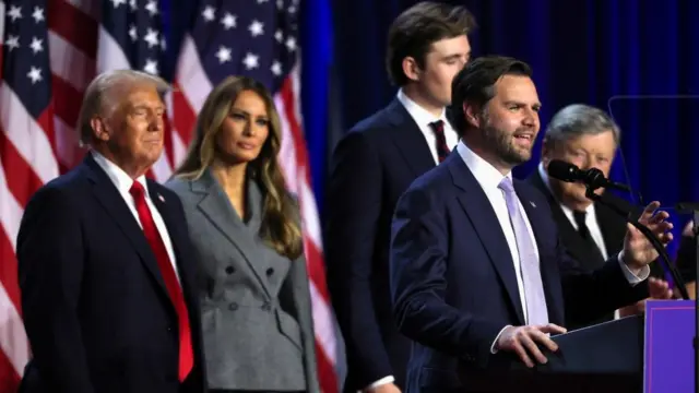 Republican vice presidential nominee JD Vance speaks in front of Republican presidential nominee and former U.S. President Donald Trump and Melania Trump following early results from the 2024 U.S. presidential election in Palm Beach County Convention Center, in West Palm Beach, Florida, U.S., November 6, 2024.