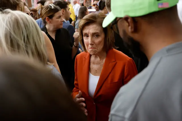 Nancy Pelosi walks through the crowd