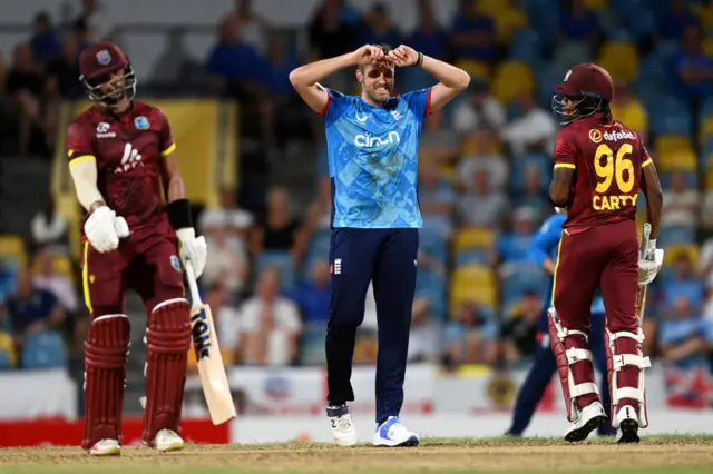 Jamie Overton of England reacts after bowling