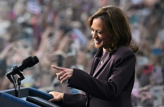 Kamala Harris stands behind a podium