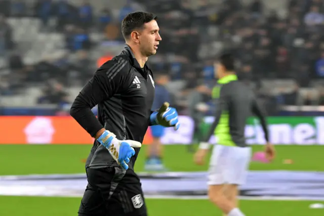 Emiliano Martinez warms up