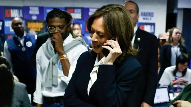 Democratic presidential nominee U.S. Vice President Kamala Harris calls voters in a last minute campaign push at the Democratic National Committee (DNC) headquarters during the 2024