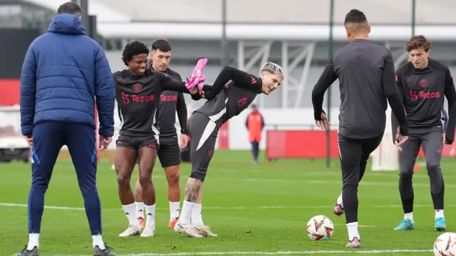 Tyrell Malacia shares a laugh with Alejandro Garnacho during Manchester United training