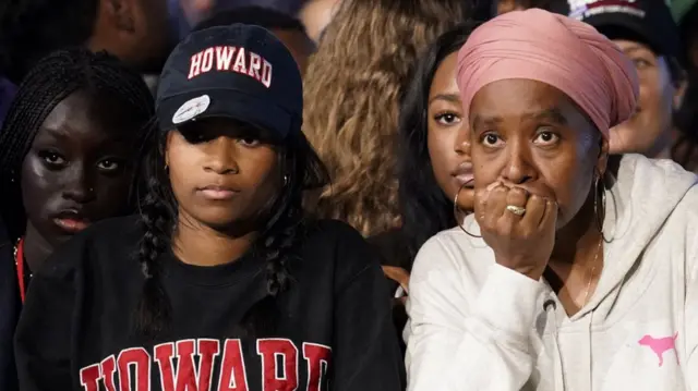 Women watch with worried looks