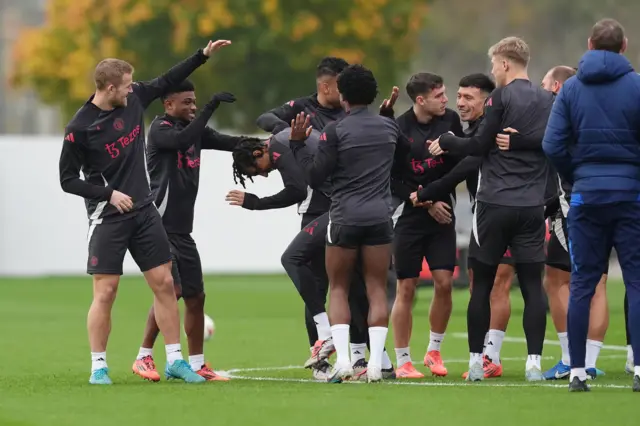 Manchester United's Leny Yoro (centre left) is embraced by Manchester United players during a training session