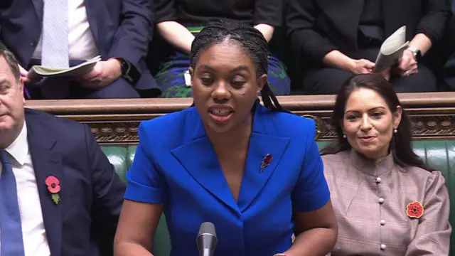 Kemi Badenoch, wearing blue, speaks at the dispatch box