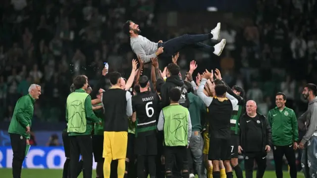 Sporting Lisbon's Portuguese coach Ruben Amorim is celebrated by his players