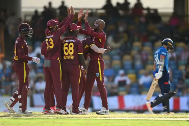 Roston Chase of the West Indies celebrates dismissing Sam Curran of England