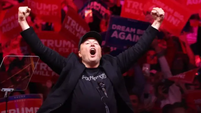 Elon Musk raises his fists in the air at a rally in support of Donald Trump at Madison Square Garden on October 27, 2024 in New York City